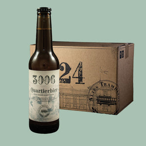 Im Vordergrund sieht man die Flasche und im Hintergrund der 24er Karton in dem die Flaschen verpackt und versendet werden.